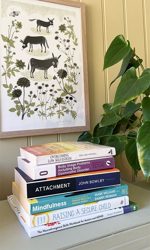 A selection of counselling and therapy books on a desk